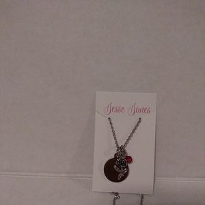 Jesse James Silver tone necklace with 3 charm rose Redstone and circle new. Chai